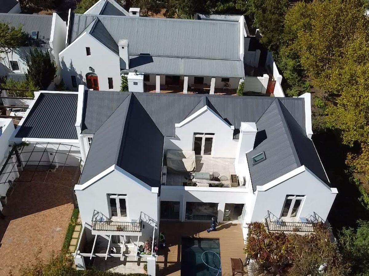 Aerial view of a Cape Dutch home with a newly sealed metal roof