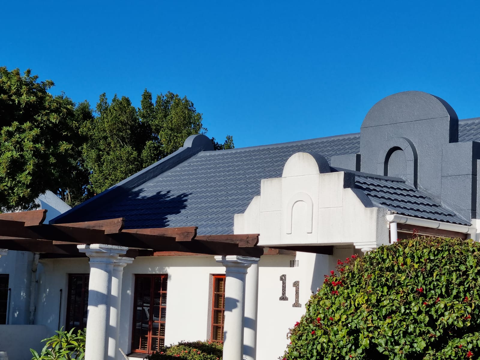 Cape Dutch home with its tiled roof and gables finished in grey