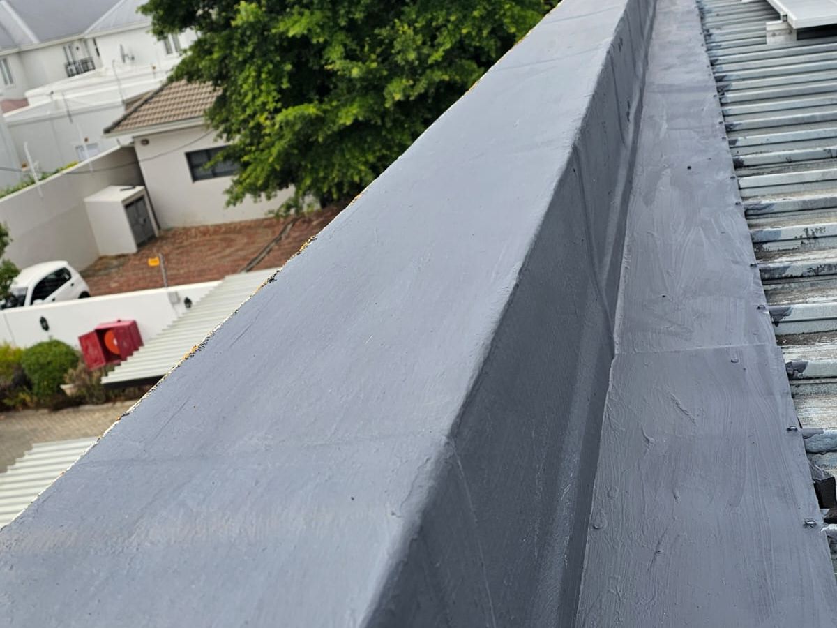 Flat roof membrane turned up into the parapet walls