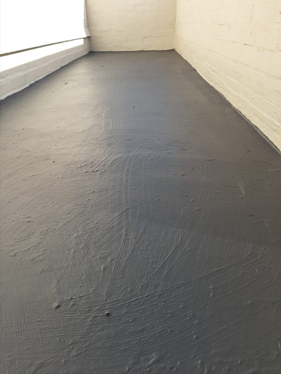 Interior floor and wall junction sealed with a liquid membrane