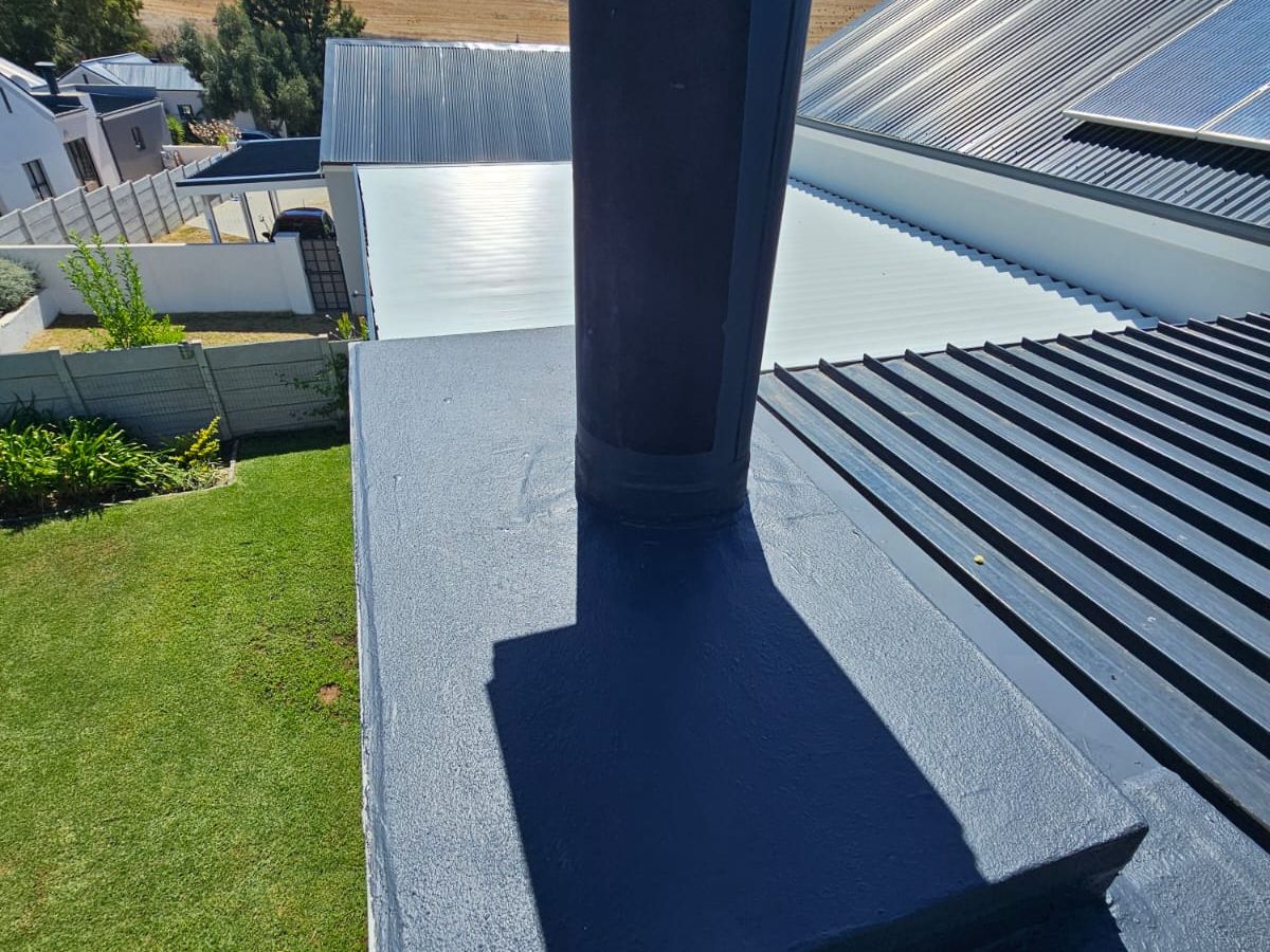 Sealed flashing detail where a flue penetrates a metal roof