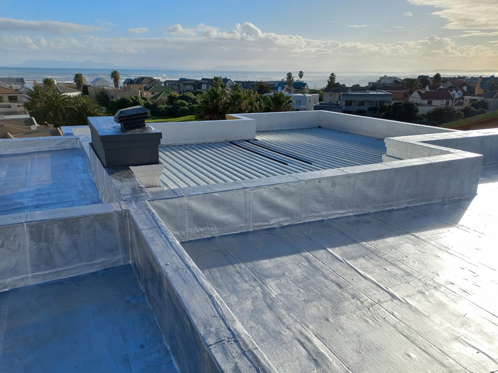 Torch-on membrane finished in reflective aluminium, turned up into the parapets